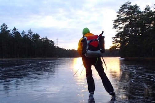 a man standing next to a body of water