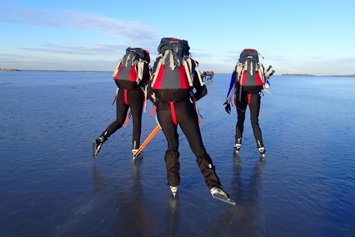 a group of people standing next to a body of water